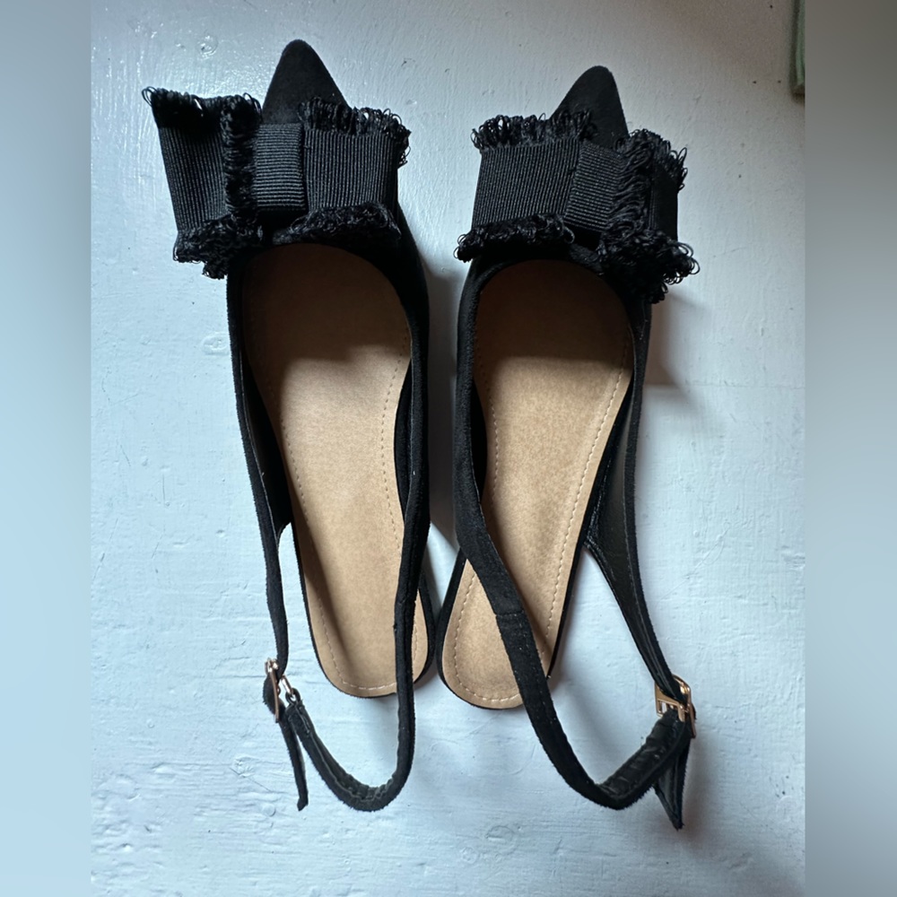 Satin fabric with statement bow, sling-back flats.